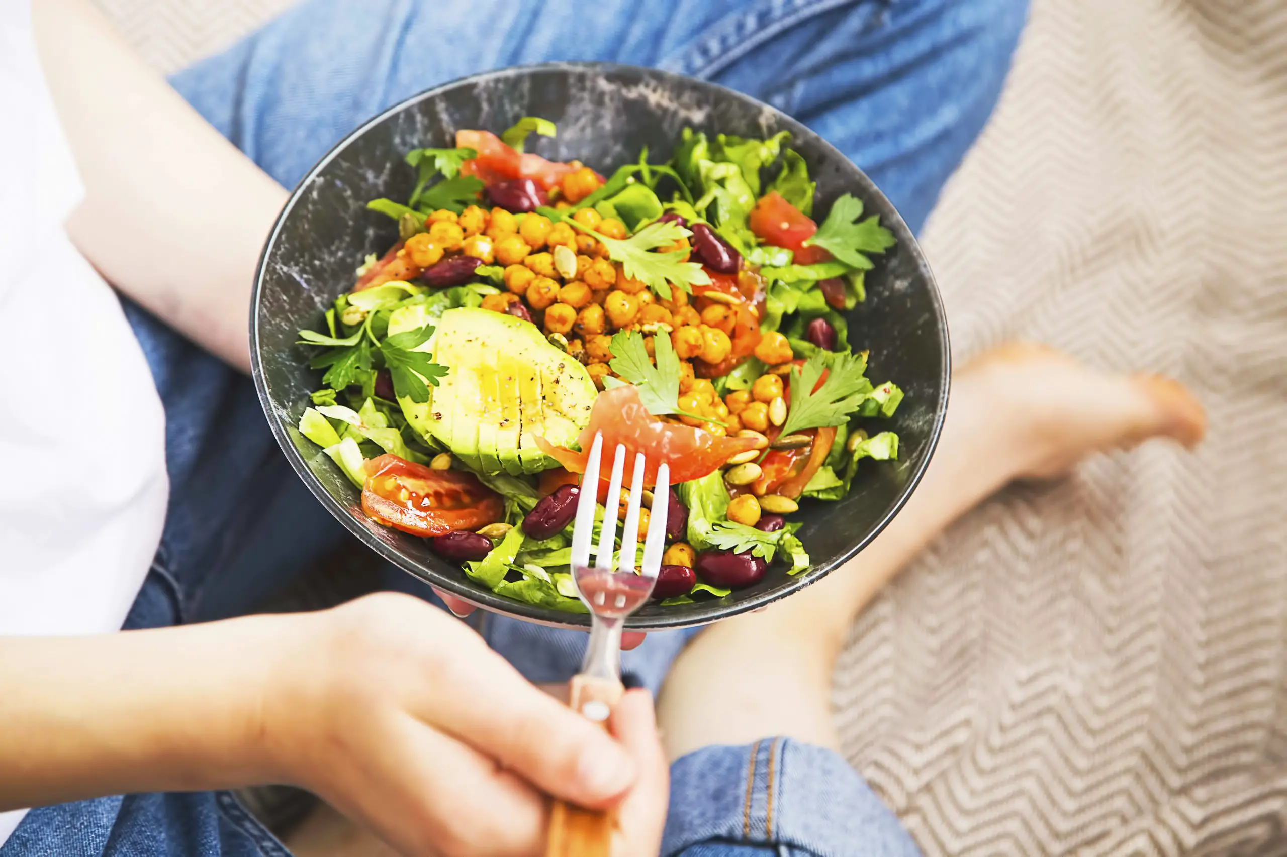 Clean eating, vegan healthy salad bowl, top view of woman holding salad bowl, plant based healthy diet with greens