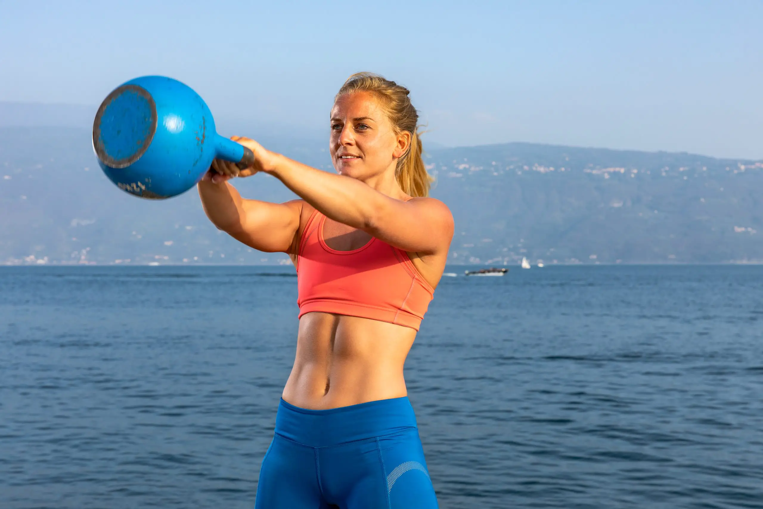 Woman using a kettlebell to get a six pack
