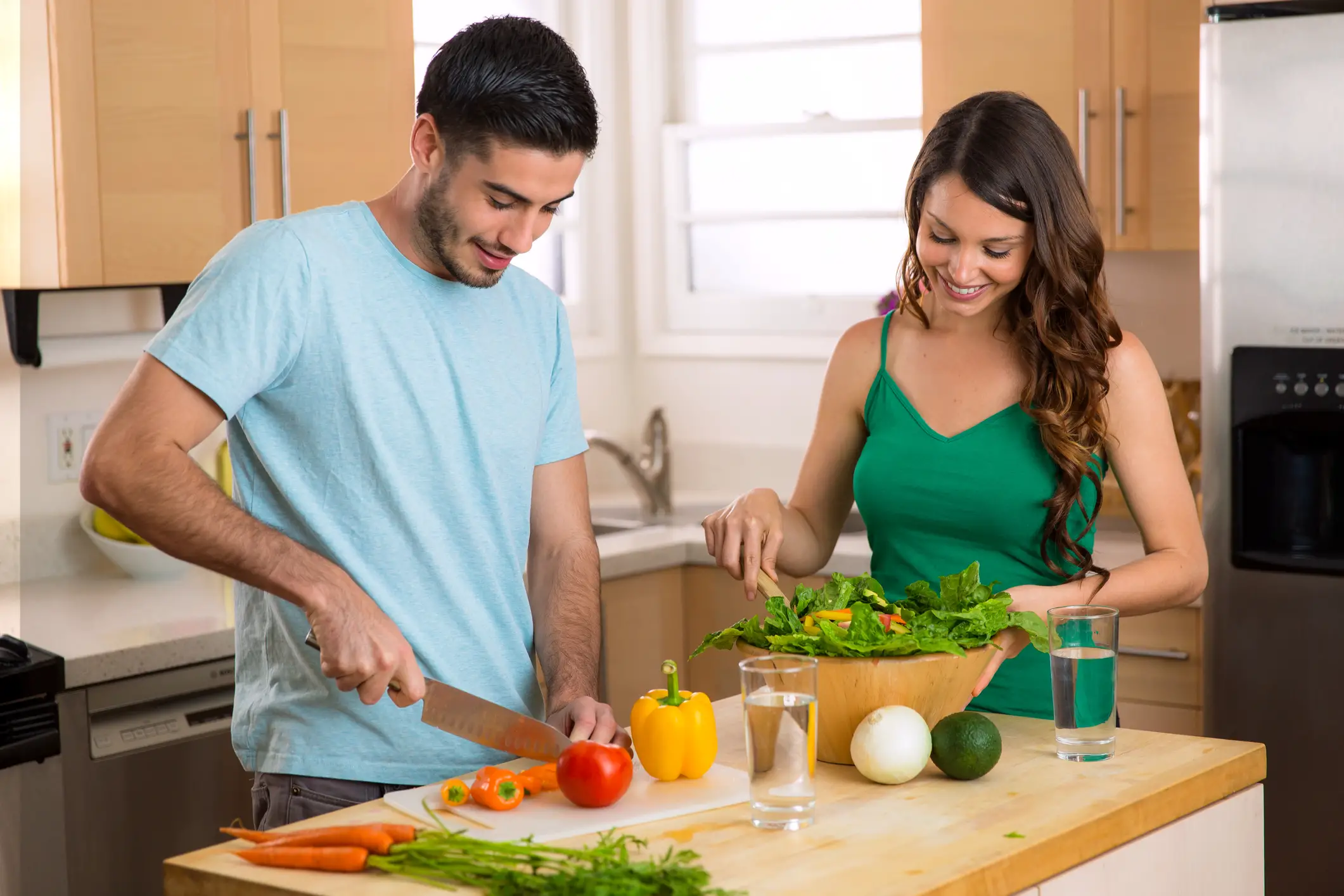 Couple preparing healthy meals to help with their fitness