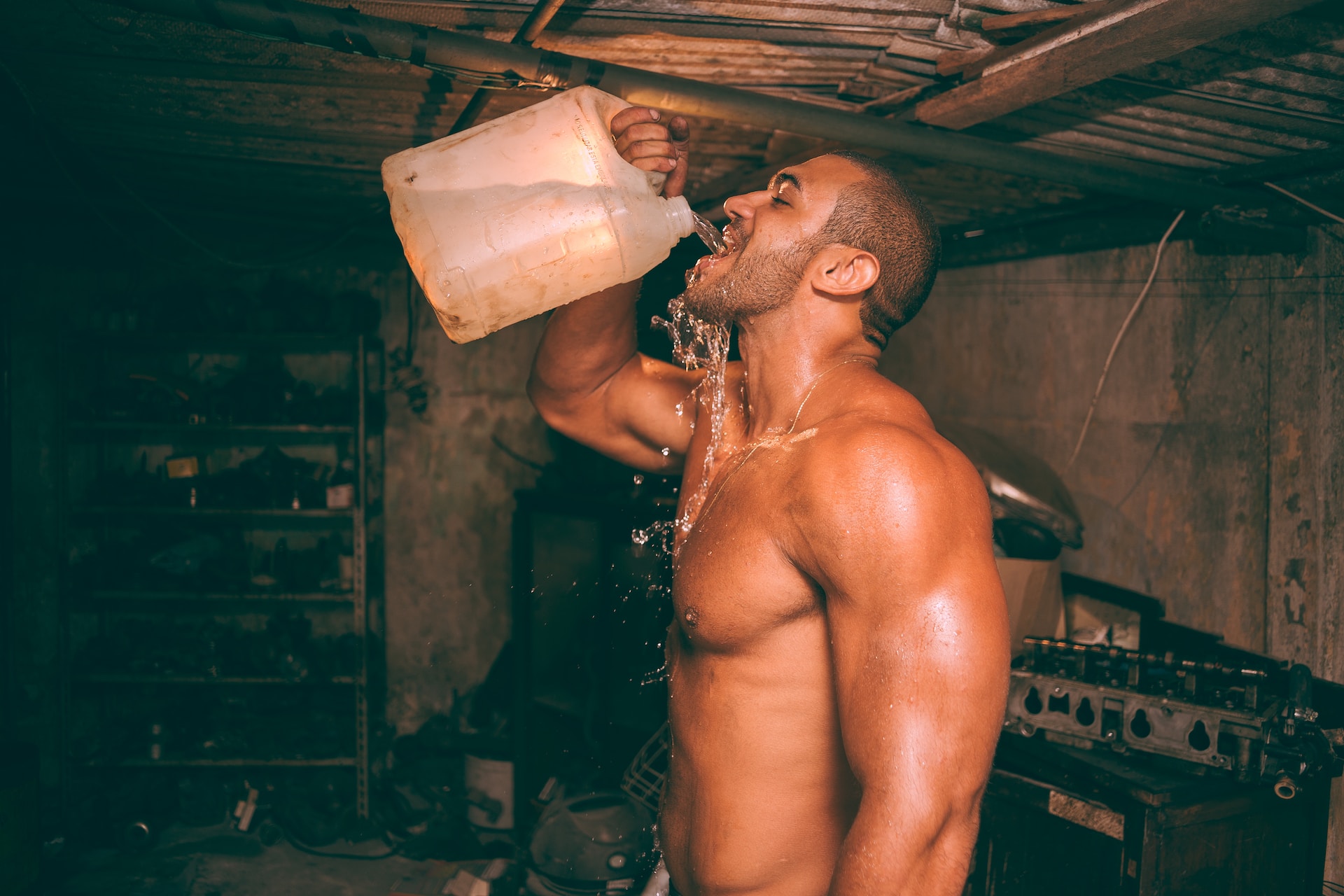 Fitness guy drinking lots of water to stay hydrated when working out