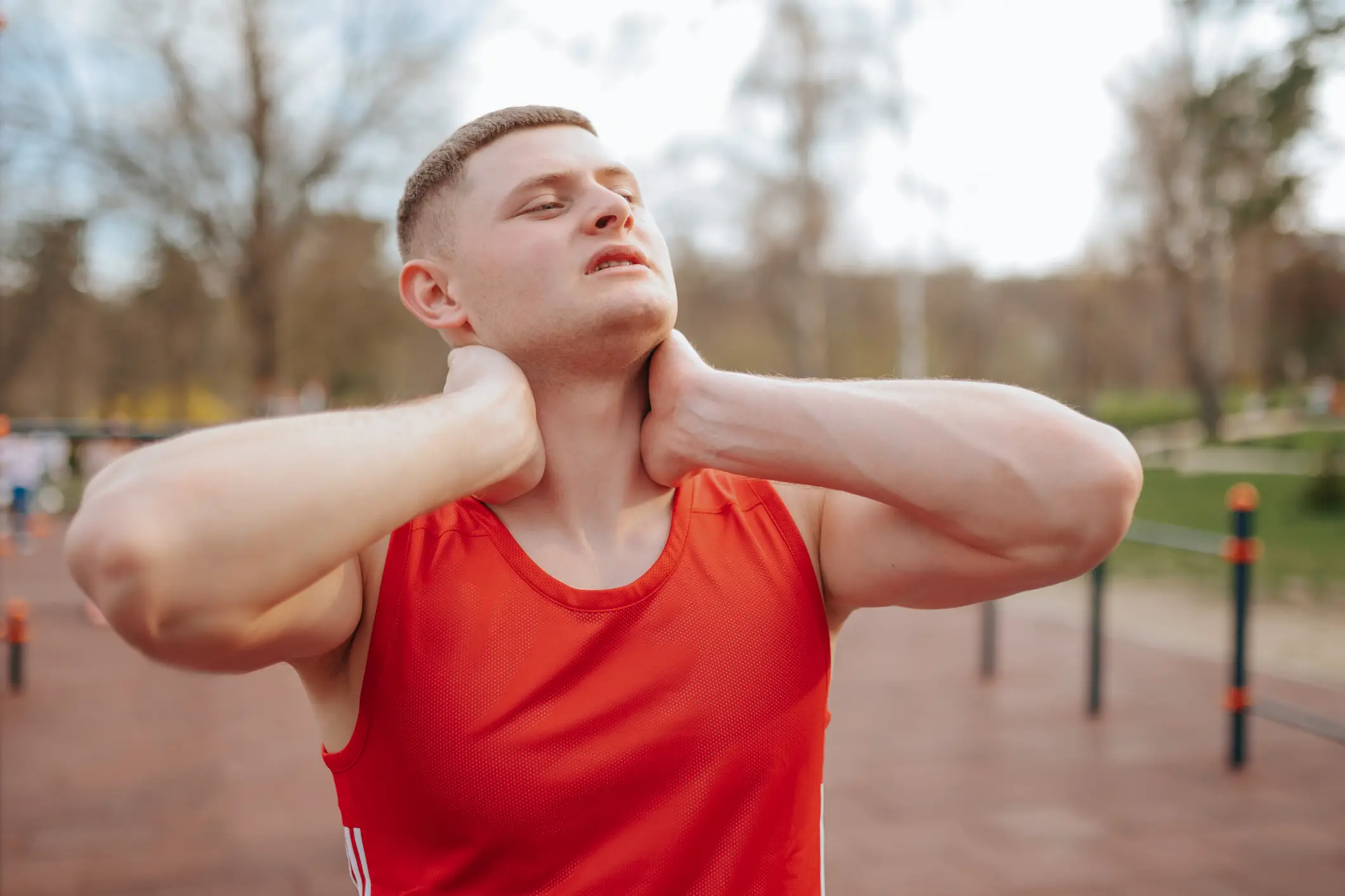 Man suffering from next strain after a strenuous workout