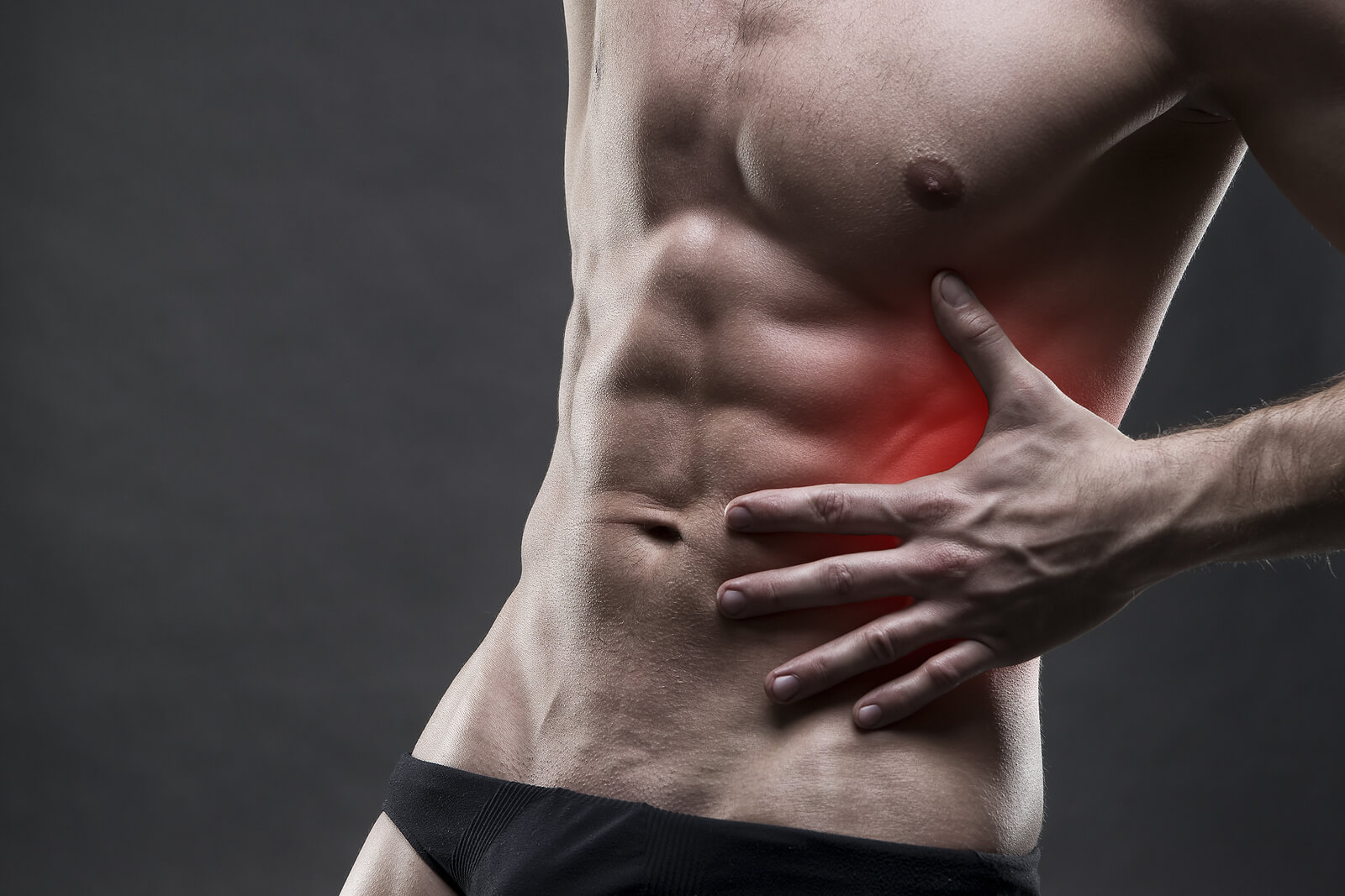 Sore ab muscles on a male body