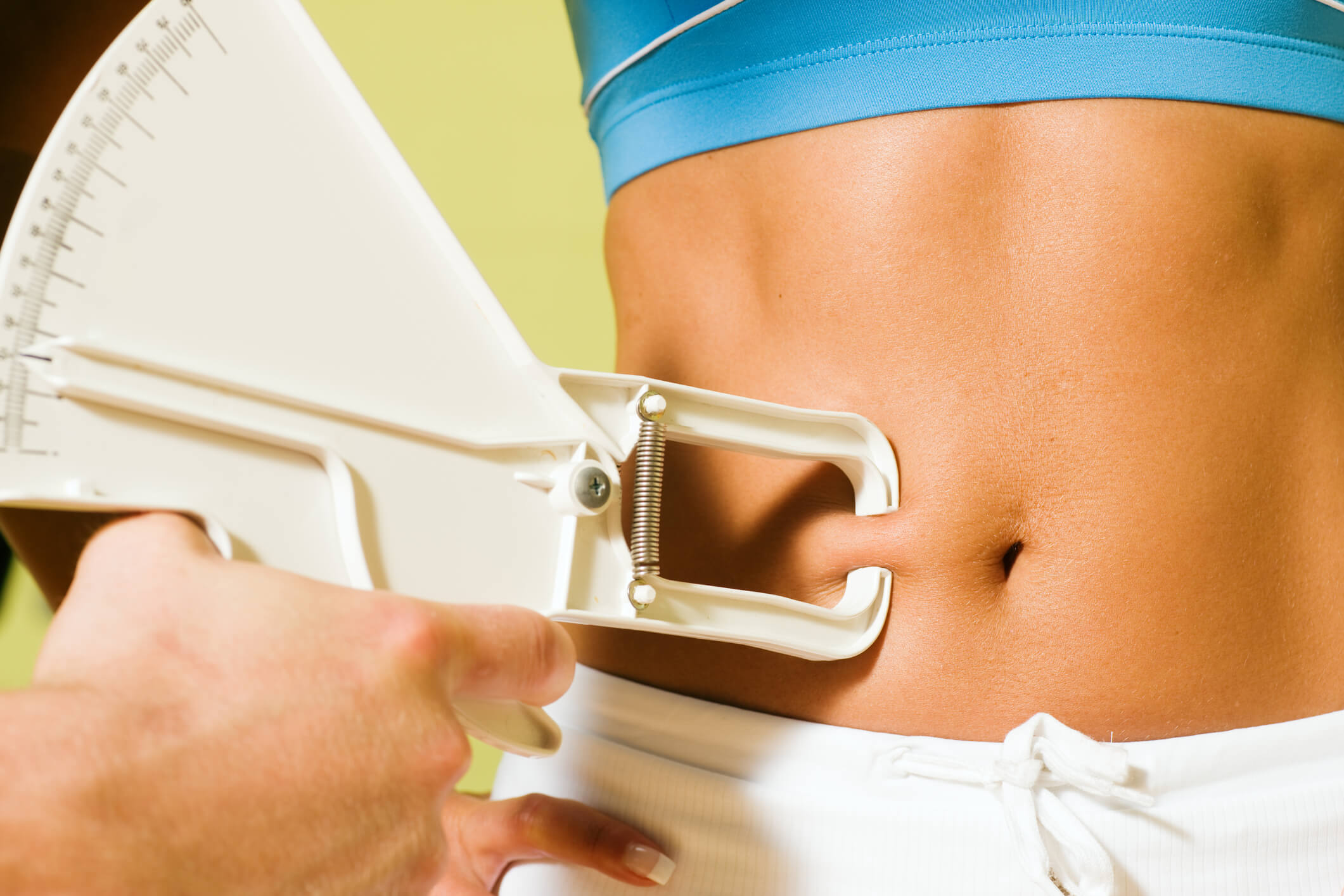 Woman being tested to ascertain her body fat percentage