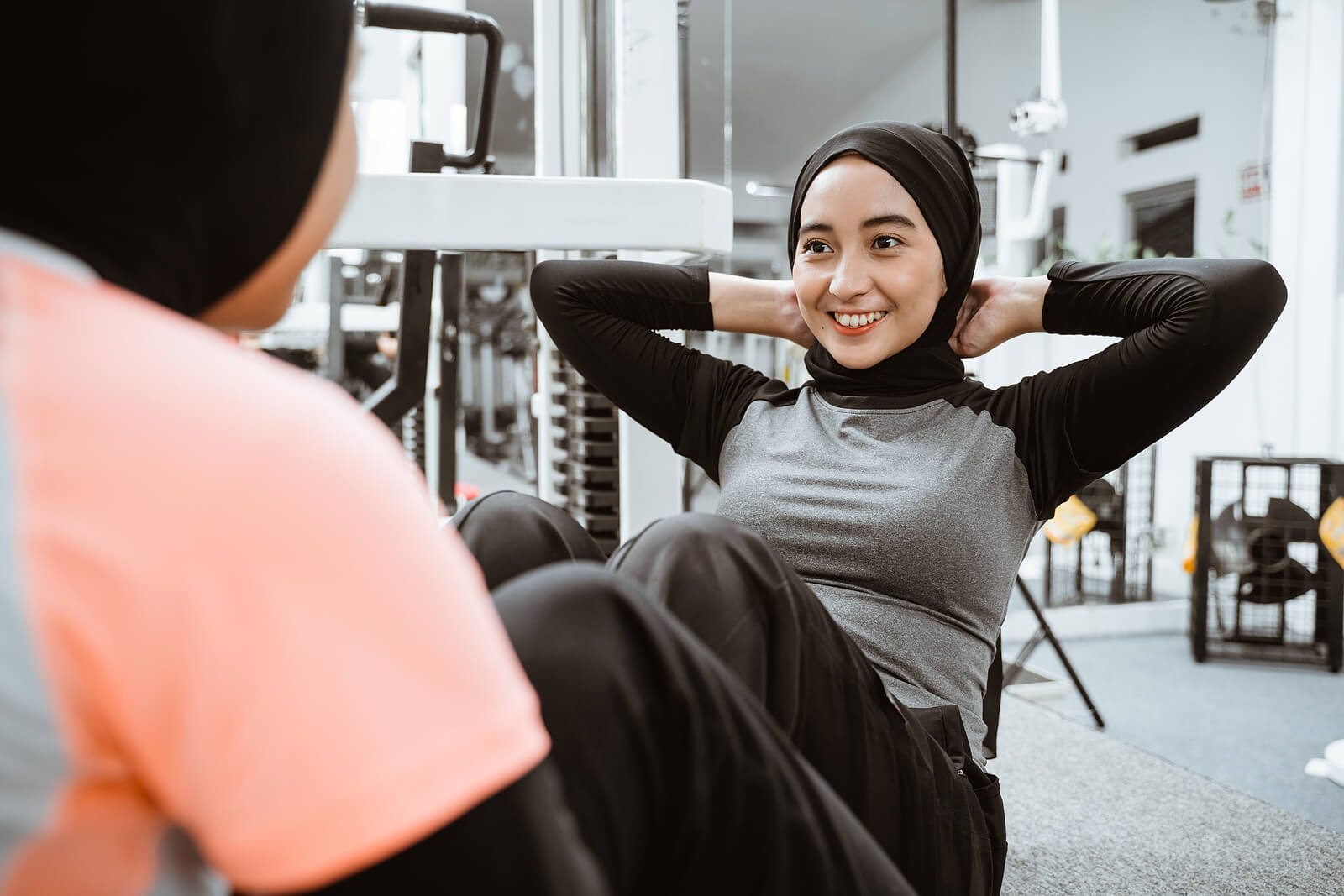 Muslim Woman Sitting Up Exercise With Partner At The Gym