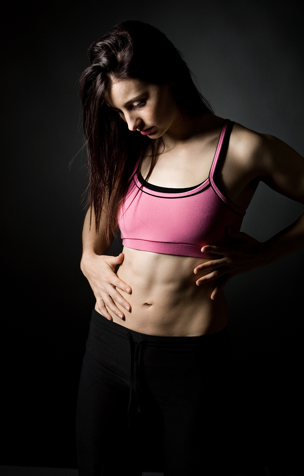 Shot Of A Sporty Female Holding Her Stomach