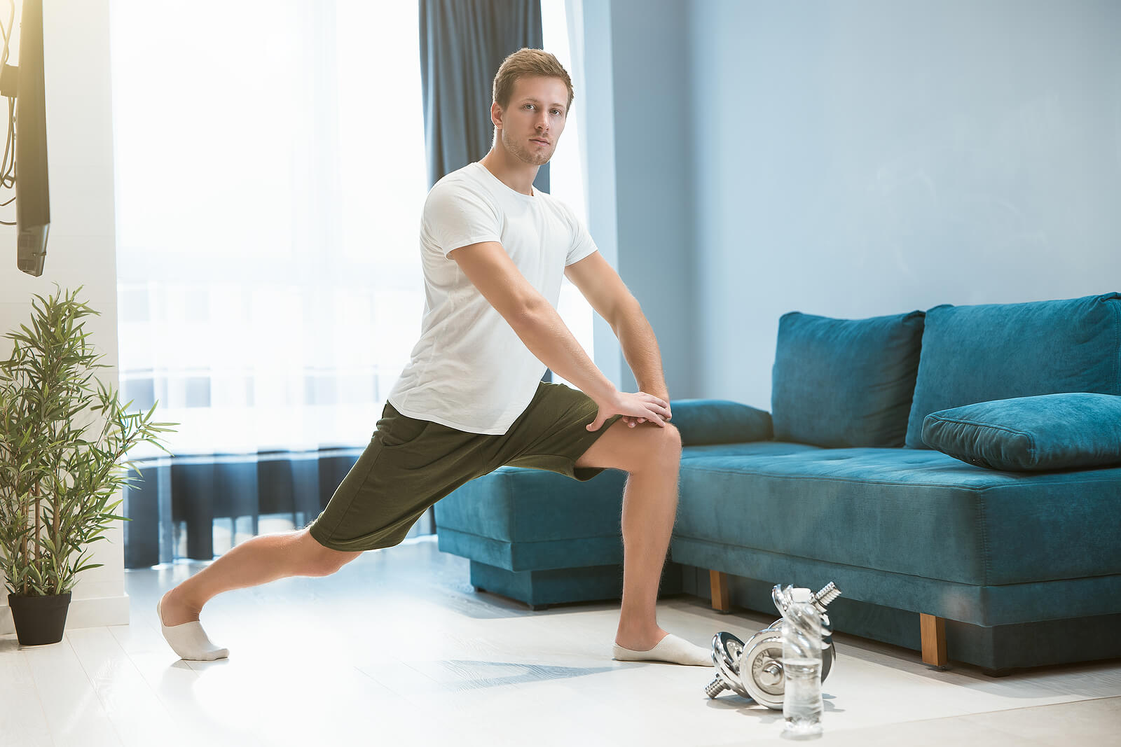 Young Handsome Man Doing Lunges During Stretching Before Workout