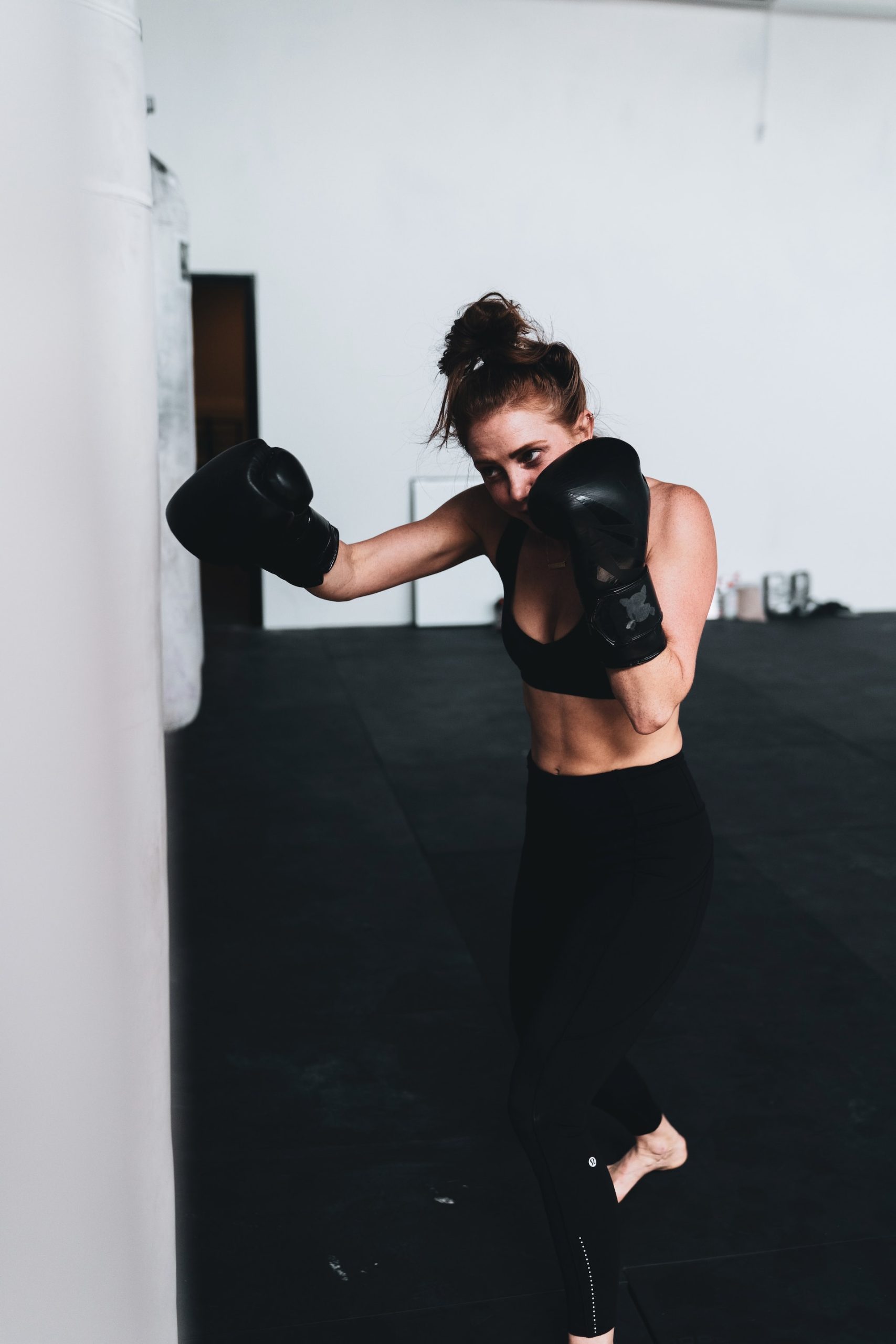 Woman punching a punch bag to strengthen her core abs