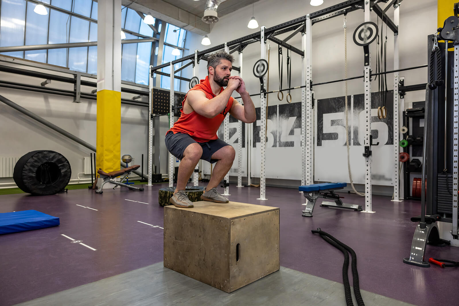 Bearded Man Having Workout, Jumping Up On Wooden Box In Crossfit
